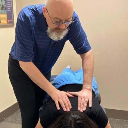 Dr. Warren adjusting woman on table