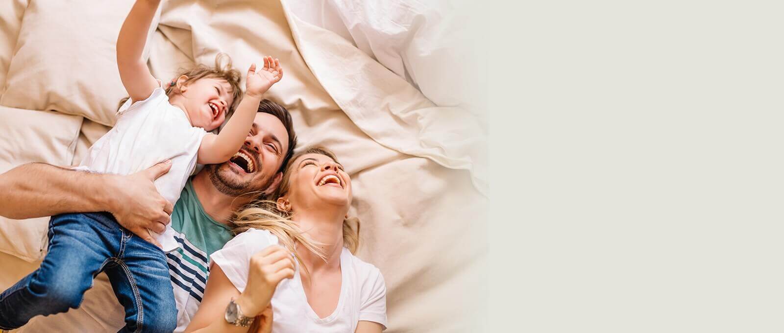 family of three laughing