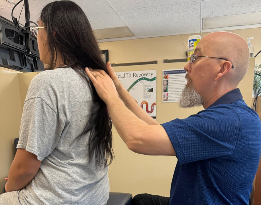 Edmonton Chiropractor Dr. Warren adjusting woman's back