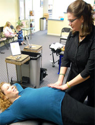 Adjustments are tailored to your size, age and particular health issue. expectant mother being adjusted by Dr. Curran.