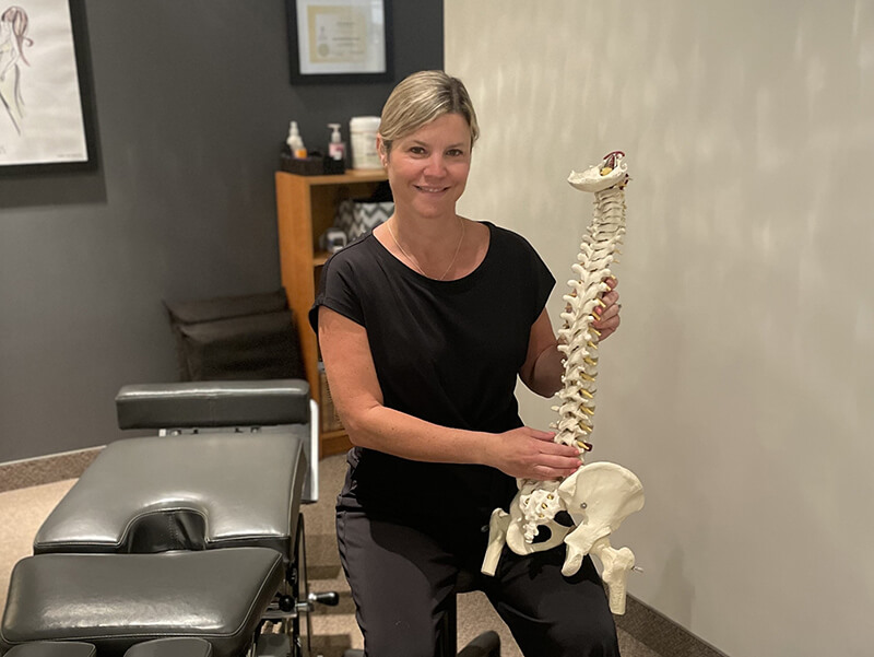 Dr. Tricia holding spine model