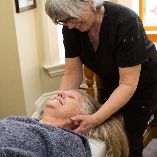 Dr. Catherine adjusting patients neck