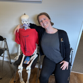 Christchurch chiropractor Dr Kim posing with skeleton