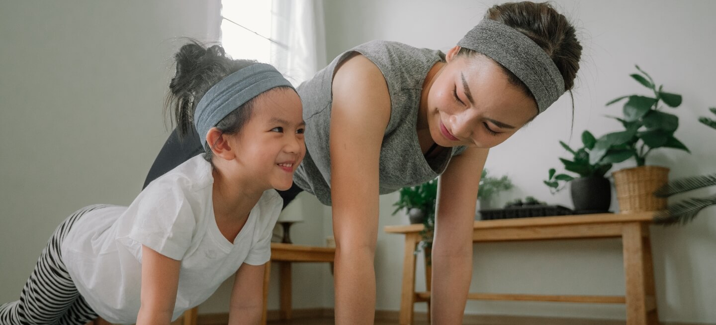 Mother and daughter doing push-ups