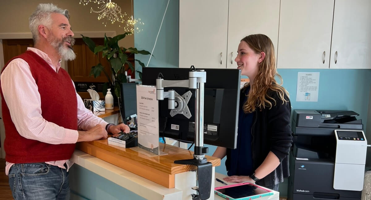 Happy Spine staff talking at reception area