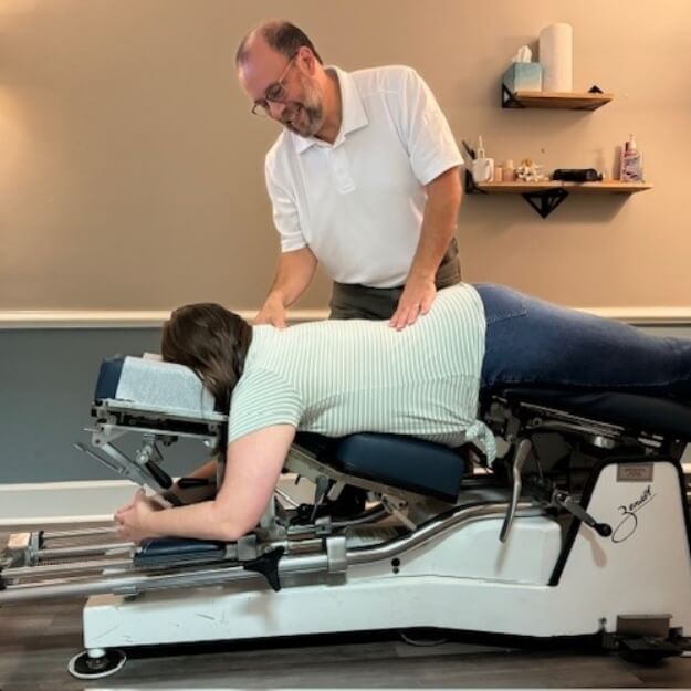 Peachtree City chiropractor Dr. Chris adjusting a pregnant lady