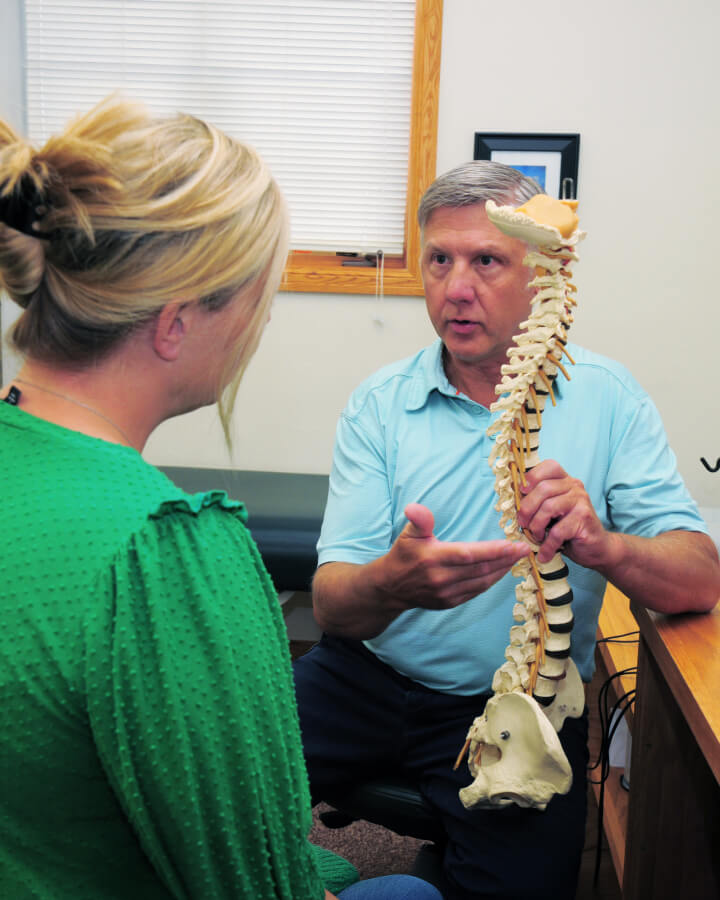 Chiropractor holding spine
