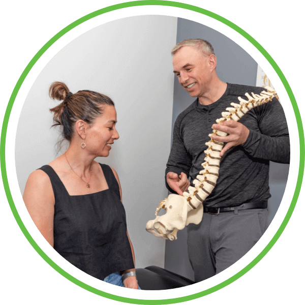 Doctor showing spine model to patient