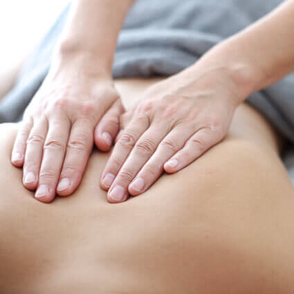 massage-therapist-massasing-womans-upper-back-sq