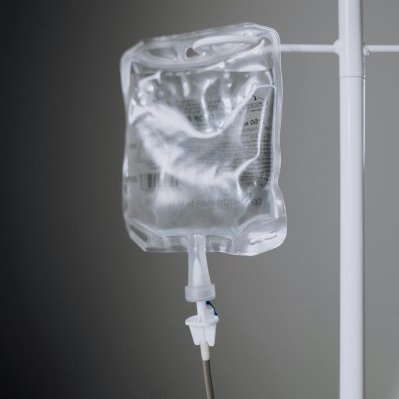 A close-up view of an IV fluid bag hanging on a pole, ideal for healthcare concepts.