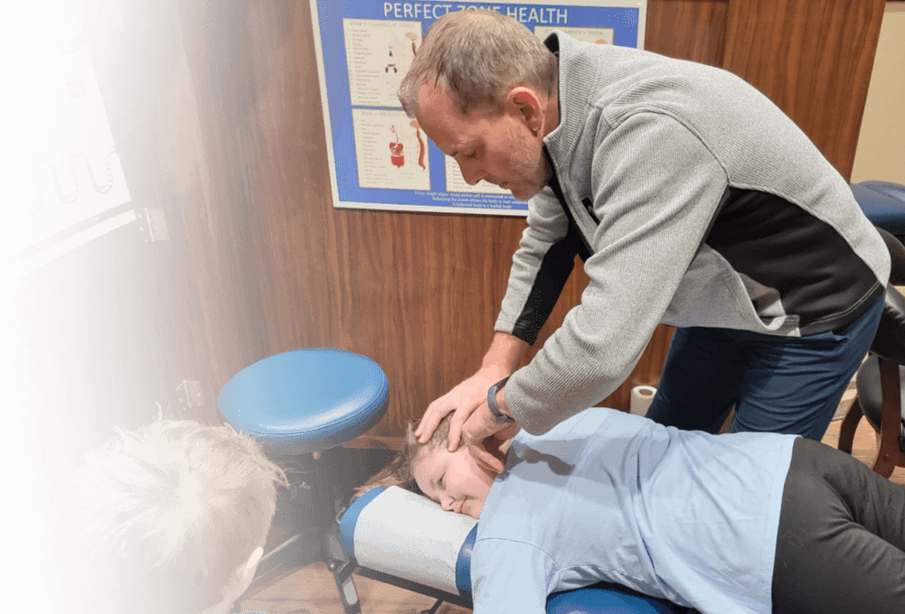 Chiropractor adjusting woman on table