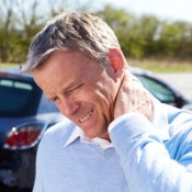 man holding neck in pain