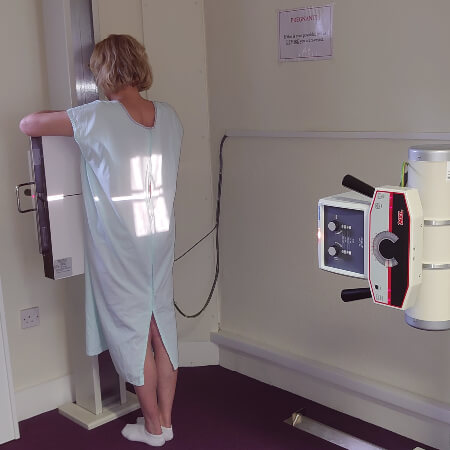 Female patient receiving an x-ray at Aligned Family Chiropractic