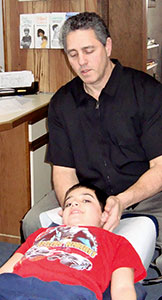 Dr. Karas adjusting a patient.