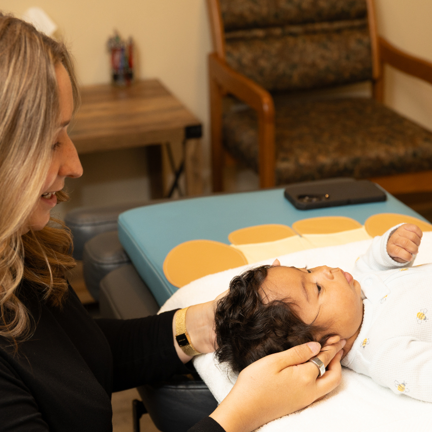 chiropractor adjusting baby's neck