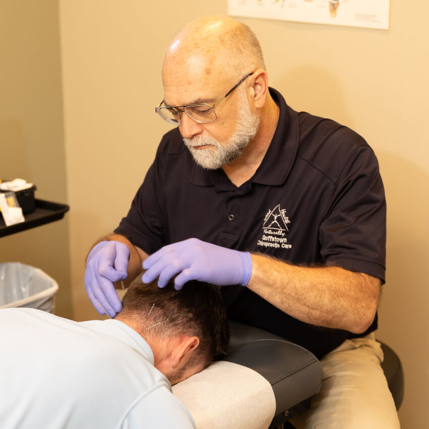 Goffstown Chiropractic Care, PLLC practitioner putting needles in patients skin