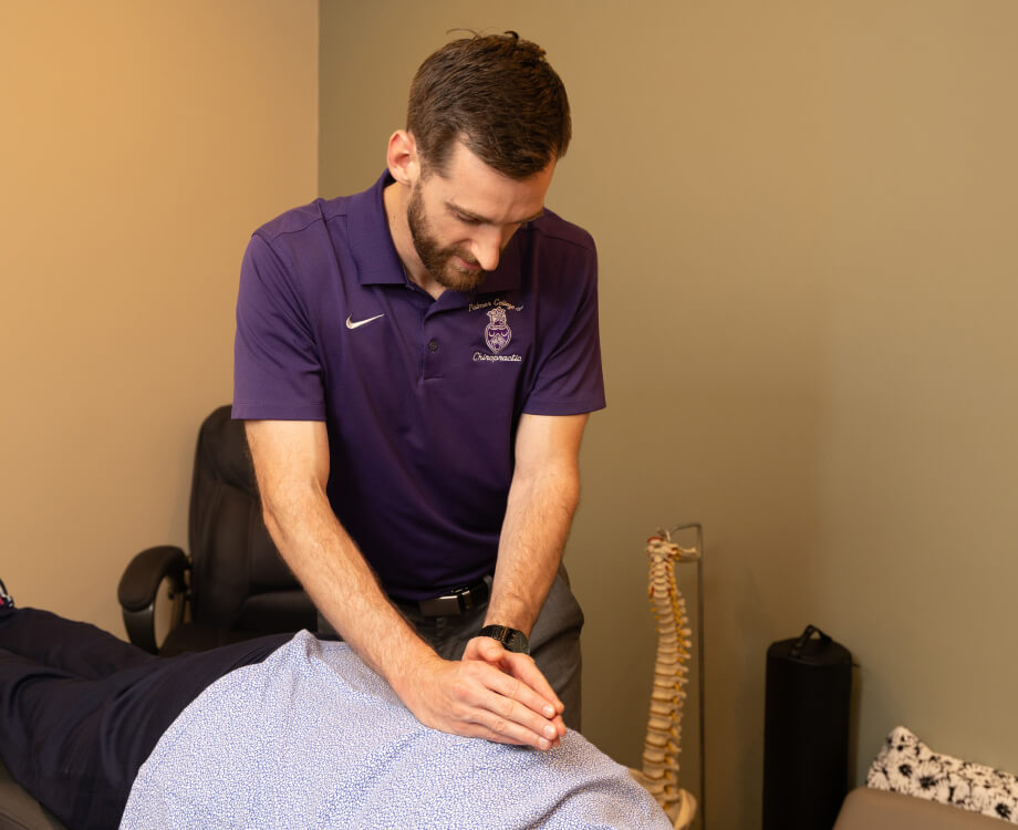 Chiropractor adjusting patient