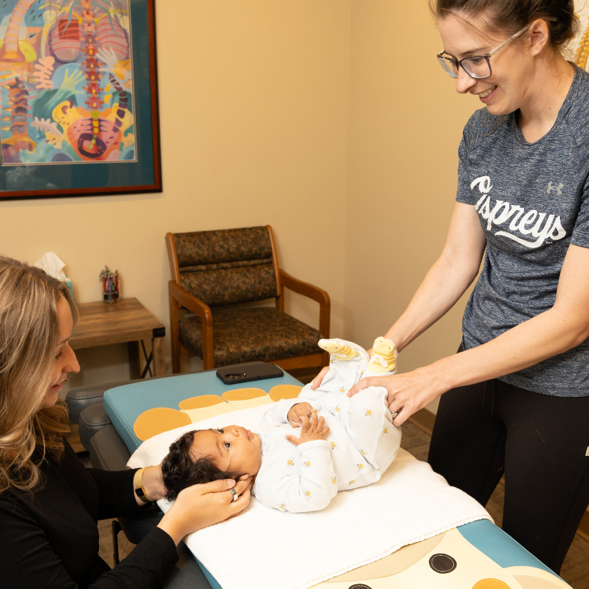 chiropractor adjusting baby's neck