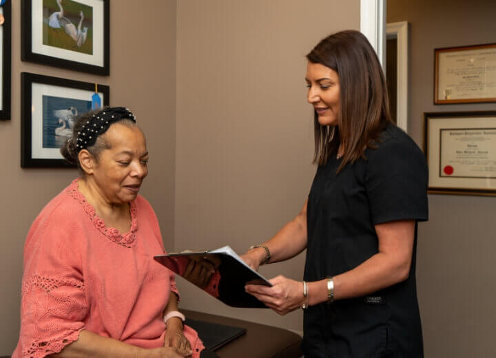 Timonium patient discussing paperwork with SPINALife staff