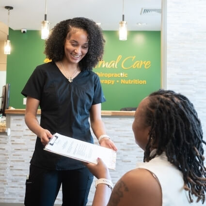 staff handing patient forms