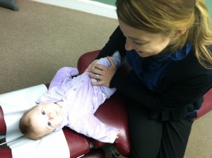 Dr. Dana treating a baby with a gentle adjustment
