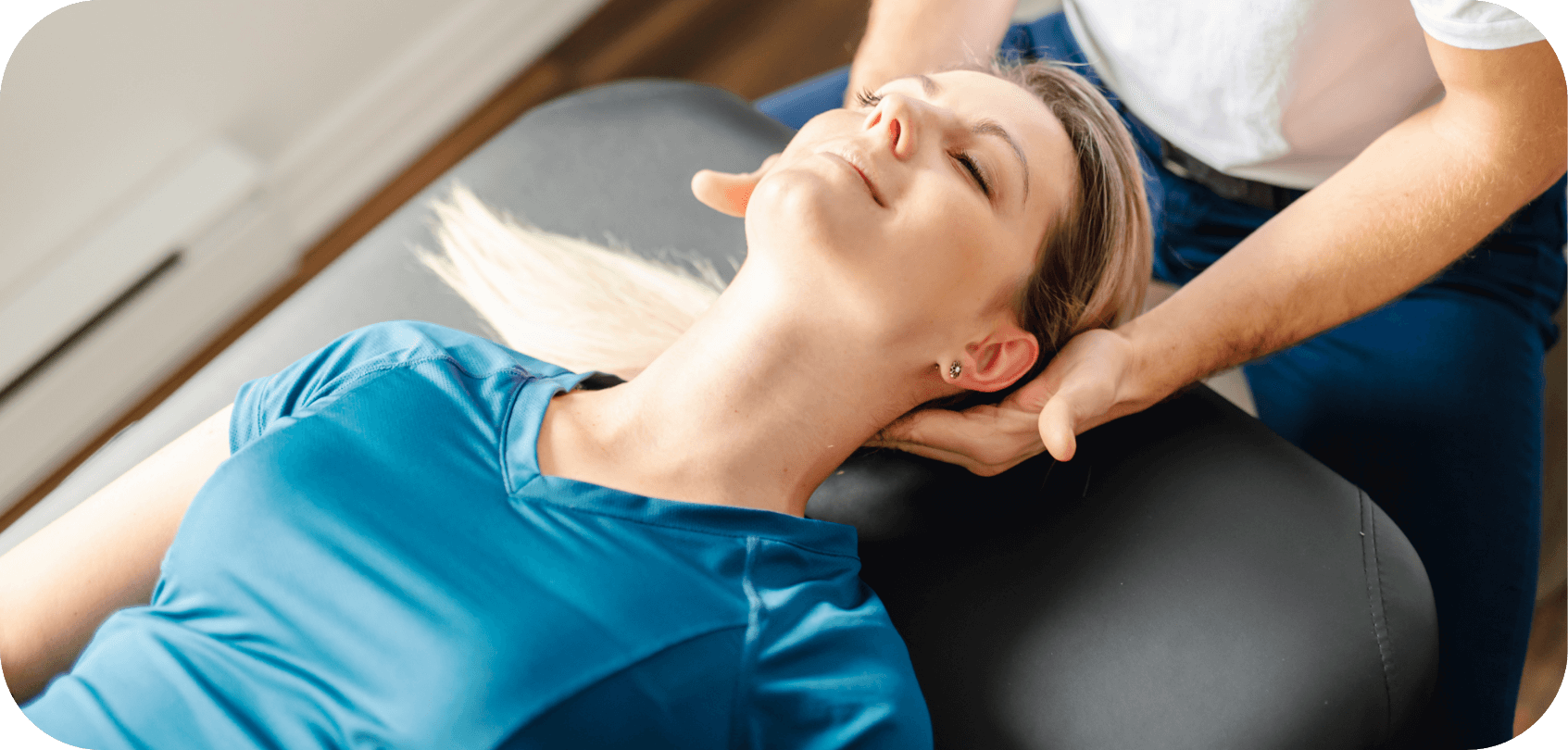 Chiropractic treating female patient with a gentle neck adjustment