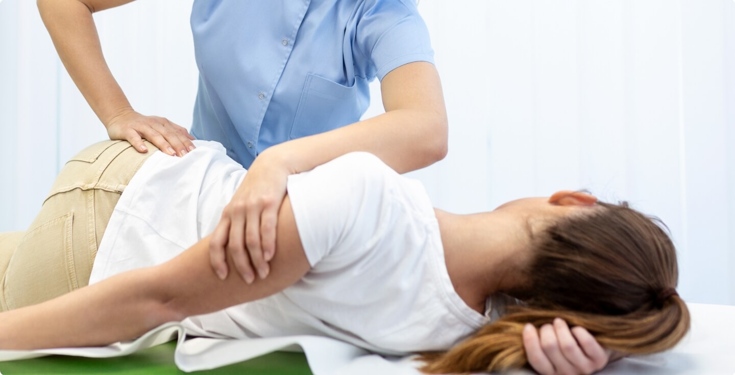 Female patient receiving a chiropractic hip adjustment
