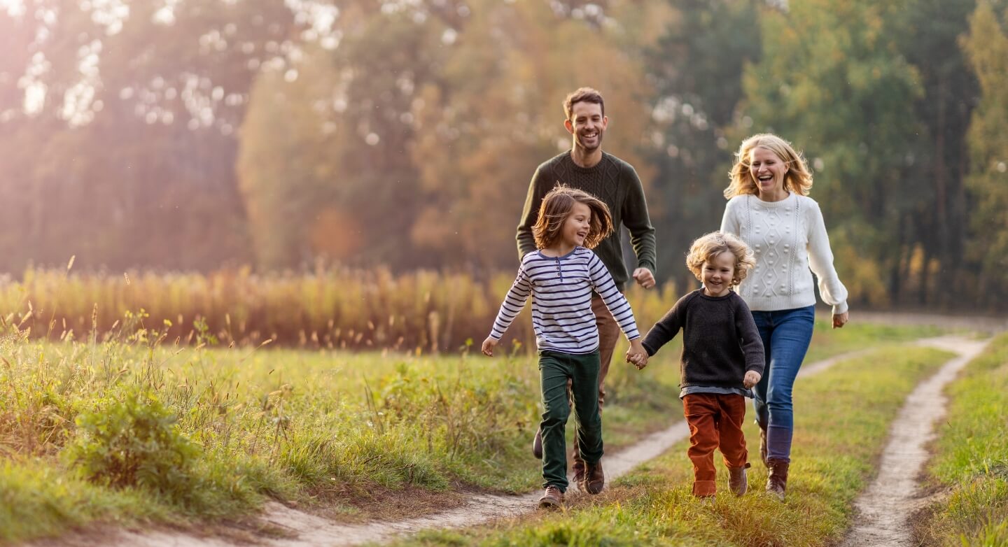 Smiling family of four out in nature