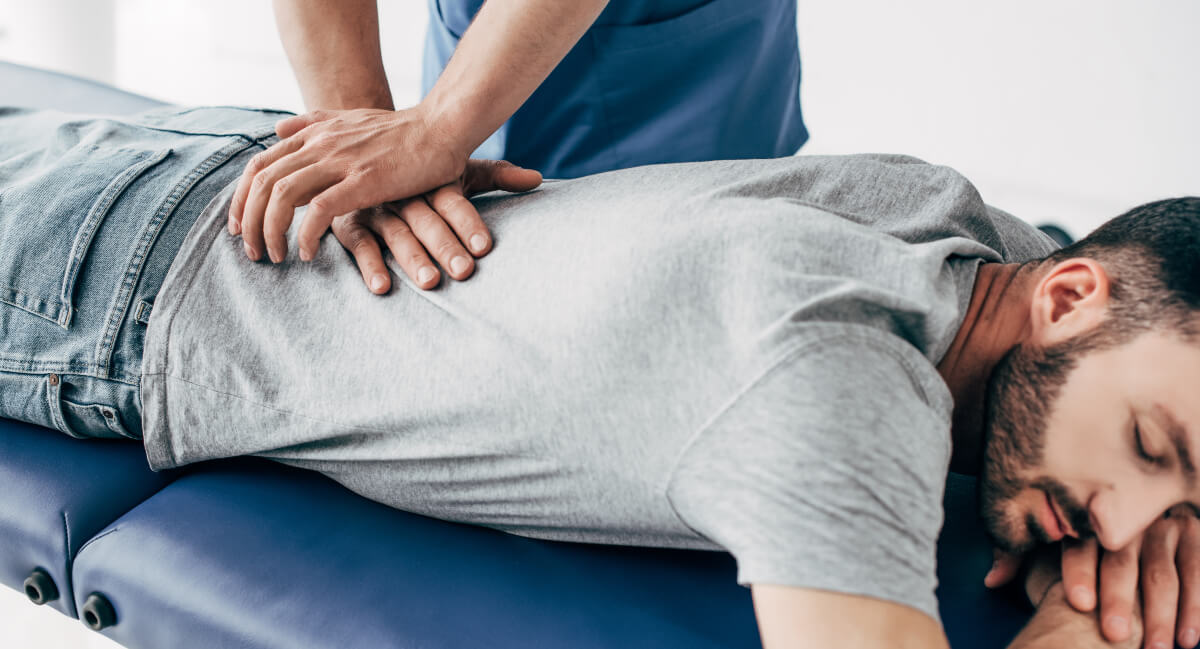 Chiropractor adjusting a male patient