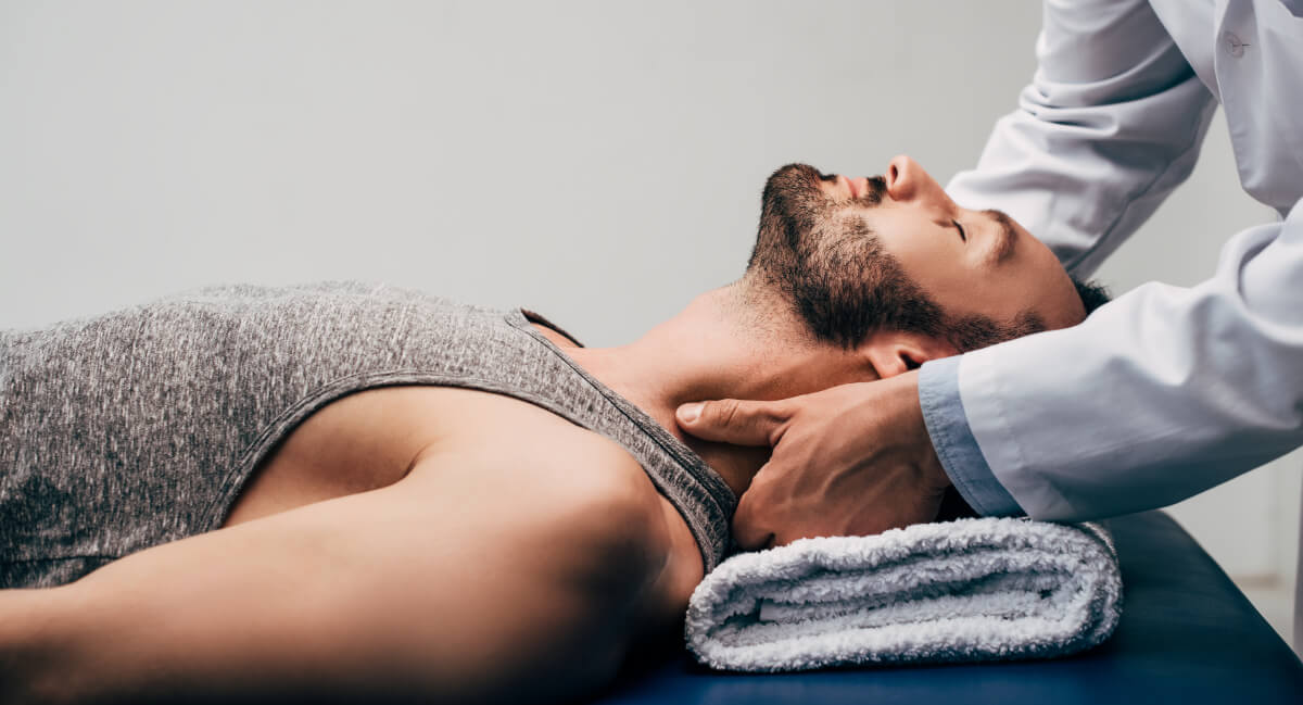 Male patient receiving a chiropractic neck adjustment