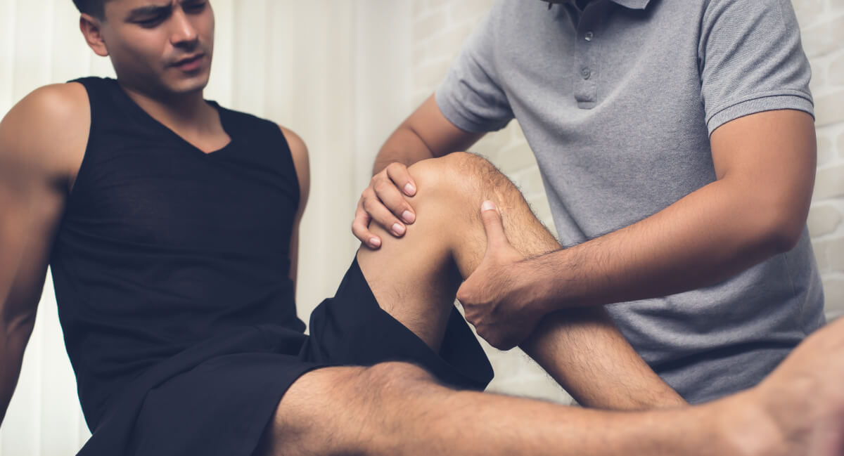 Chiropractor adjusting patient's leg