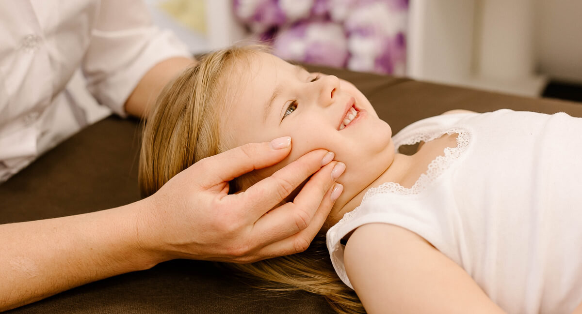 Chiropractor adjusting a pediatric patient