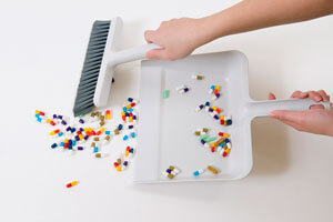 pills in dustpan