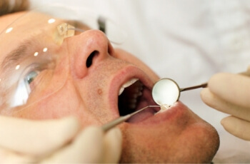 Man-examined-by-dentist.