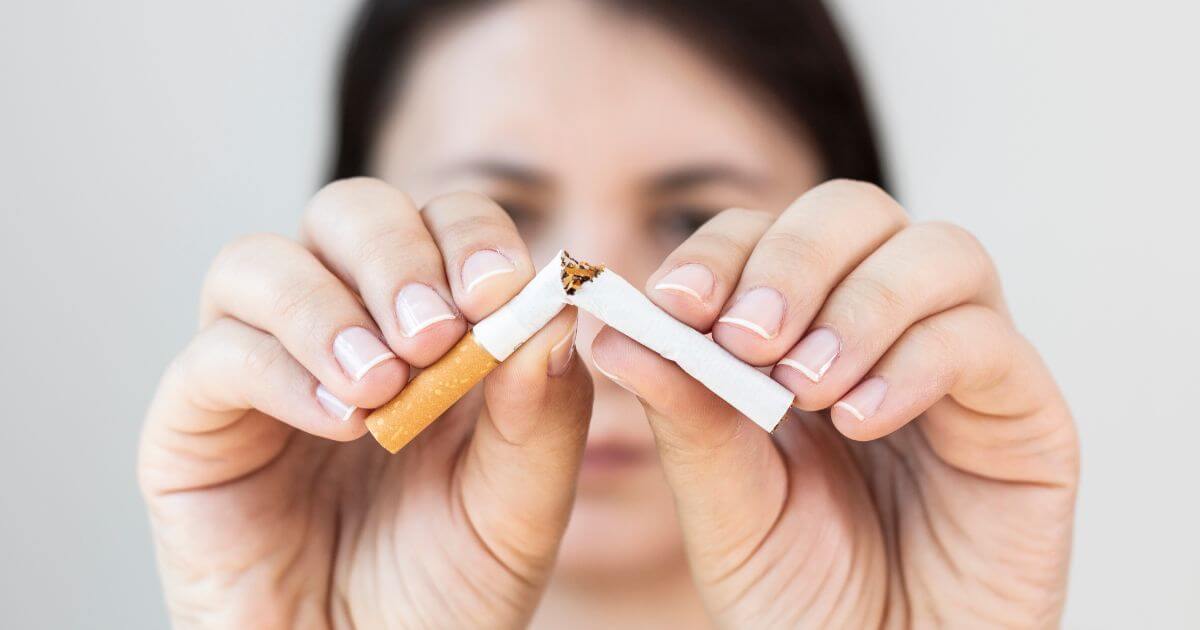 Woman breaking cigarette.