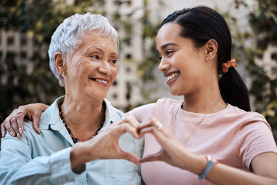 mom and daughter making heart shape with hands