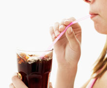 Woman sipping soda through a straw