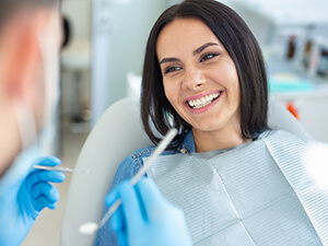woman sitting in dentists chair smiling