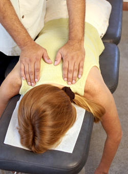 Chiropractor adjusting patient