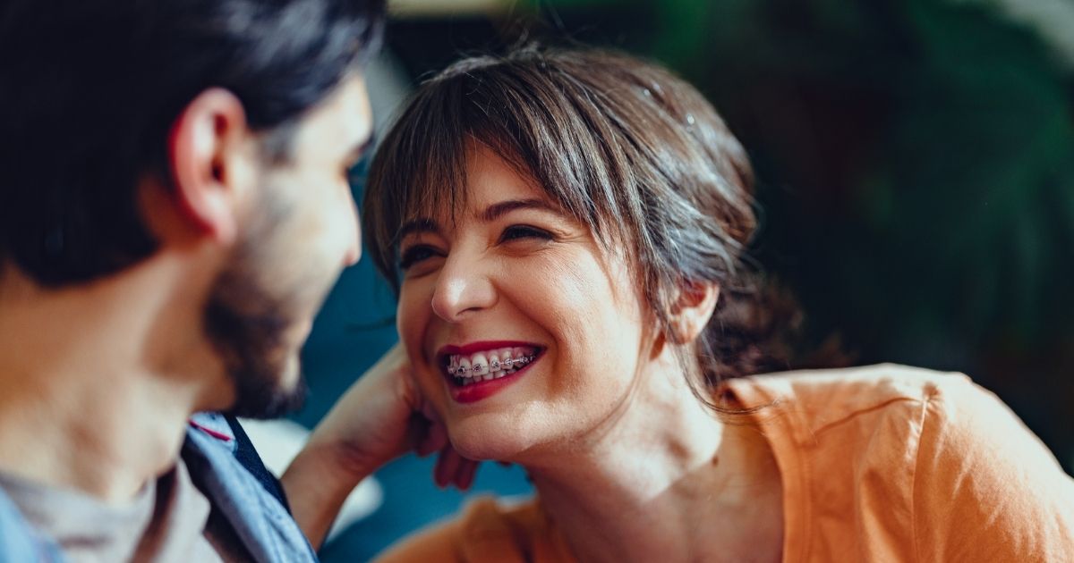 Adult woman smiling with braces.