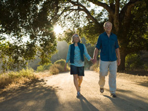 Elderly couple walking and holding hands