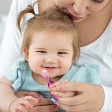 Mom and baby brushing teeth