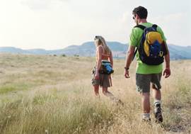 Woman and man hiking in the fields