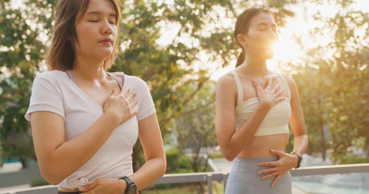 Women practicing breath work.