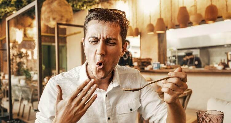 Man eating spicy food.