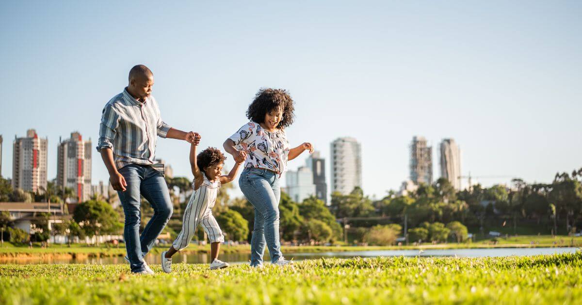 Family playing in park.