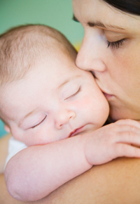 Woman kissing infant child