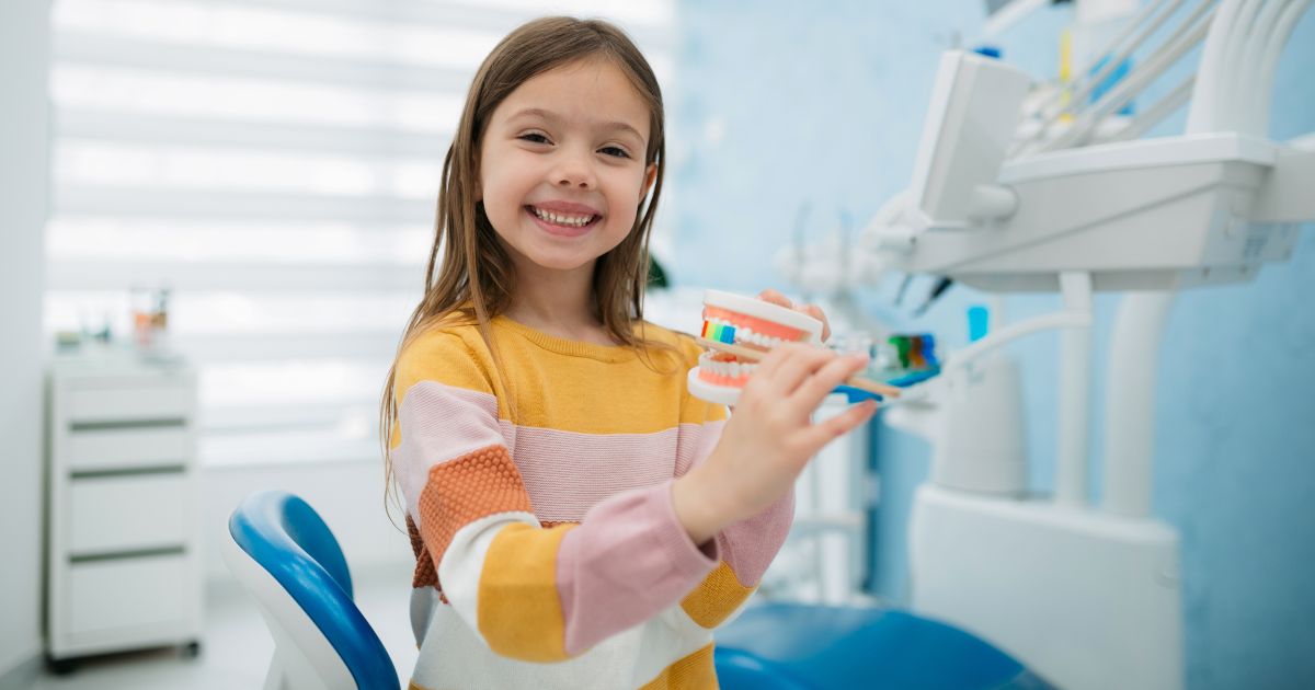 Young girl smiling in dental office.