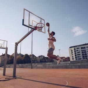 Man about to dunk a basketball