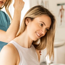 woman having neck adjusted